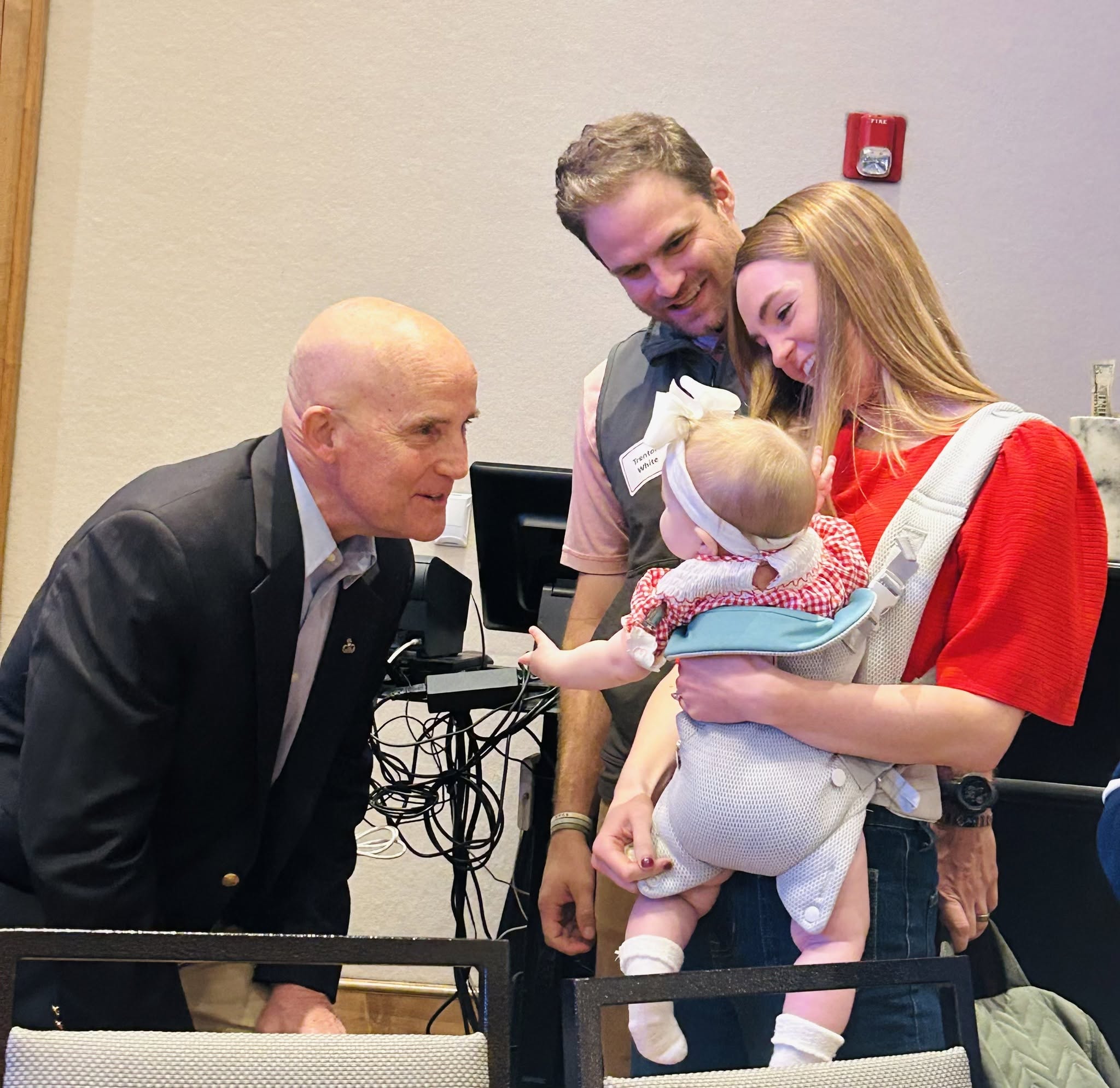 Keith Self greeting a young family